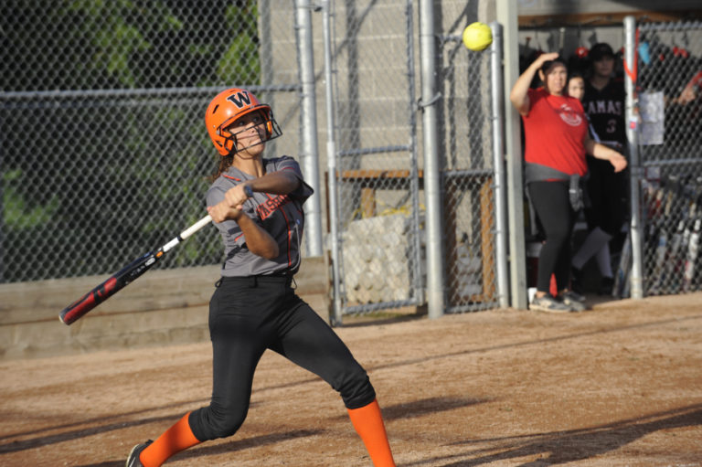 A Camas High School softball player swings at after a high-arcing pitch during the Papermakers&#039; Sept. 25 game against Washougal High School.