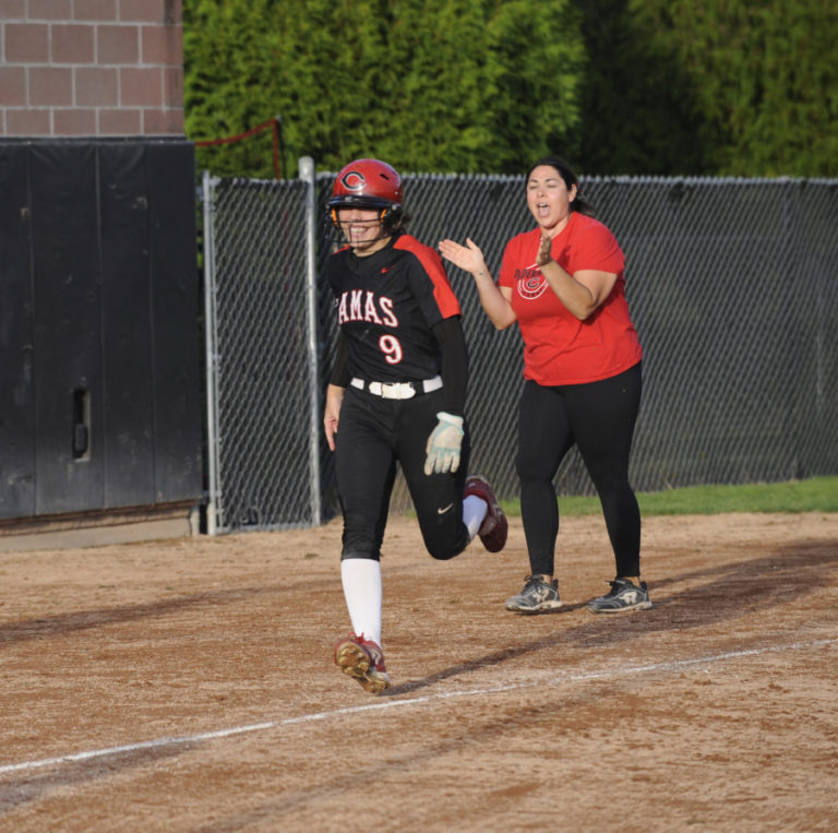 Camas High School senior Sophie Franklin rounds third base after hitting a walk-off home run against Washougal on Sept. 25. Papermakers coach Mandy Cervantes celebrates in the background.