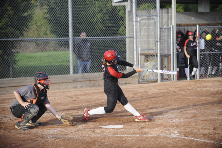 Camas High School senior Sophie Franklin crushes a softball over the left field fence to give the Papermakers an 8-7 come-from-behind victory over Washougal High School on Sept.