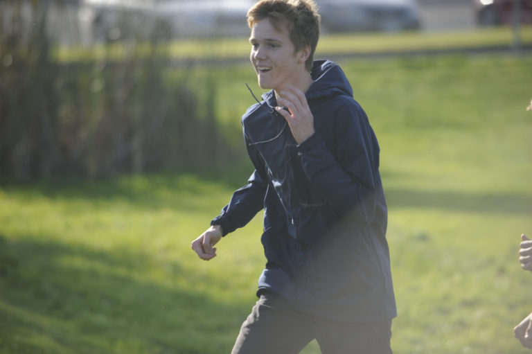 Camas High School runner Sam Geiger warms up during a practice session Monday, Oct. 14.