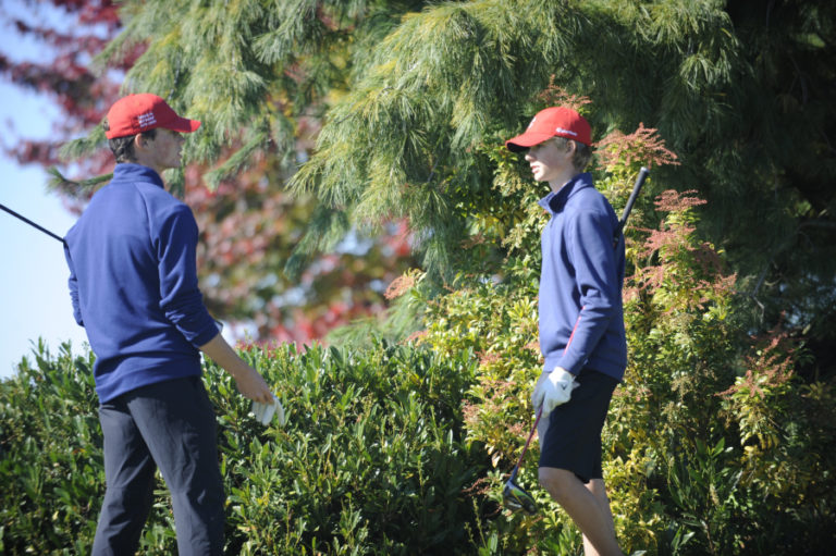 Camas High School golfer Owen Huntington (left) talks with his younger brother Eli while waiting at the No. 7 tee during the 4A District 4 tournament at Tri-Mountain Golf Course in Ridgefield on Oct. 10.
