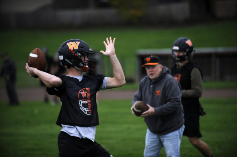 Washougal High School senior quarterback Dalton Payne (left) works on technique with assistant coach Bill Gladden (center) in preparation for the Panthers&#039; Oct. 25 showdown against Hockinson High School.