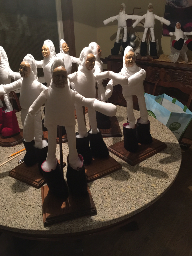 A group of &quot;naked Santas&quot; stands ready for crafter Sandy Havrelly to put their beards, hair and clothing on their cotton-batting-filled bodies.