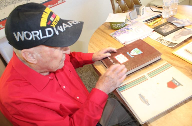 Washougal resident Ken Shold looks at journals detailing the activities of the United States Army&#039;s 304th regiment and 76th division during World War II.
