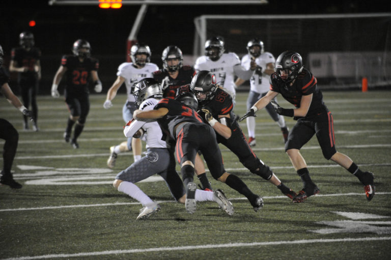 Camas High School defensive players swarm a Union High School running back during the Papermakers&#039; 28-14 victory at Doc Harris Stadium in Camas on Nov. 1.