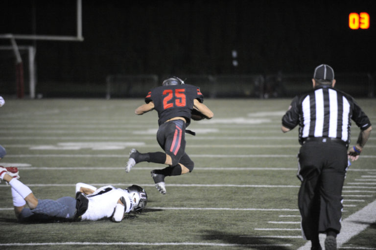 Camas High School junior running back Gabe Gua breaks free to pick up a first down against Union High School on Nov. 2.
