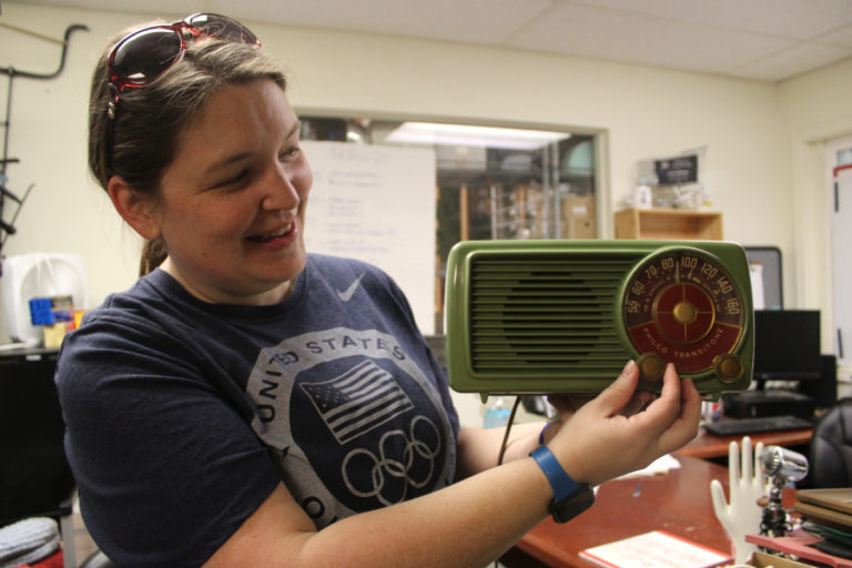 Terra Heilman, coordinator of Repair Clark County, shows a vintage radio repaired by Pat Kogi, president of the Northwest Vintage Radio Society, at ReTails Thrift Store on Friday, Nov. 8.