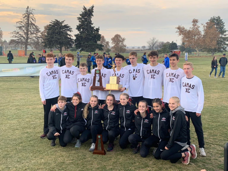 The Camas High School boys cross country team hoists the team&#039;s first team state championship trophy on Nov. 9 in Pasco.
