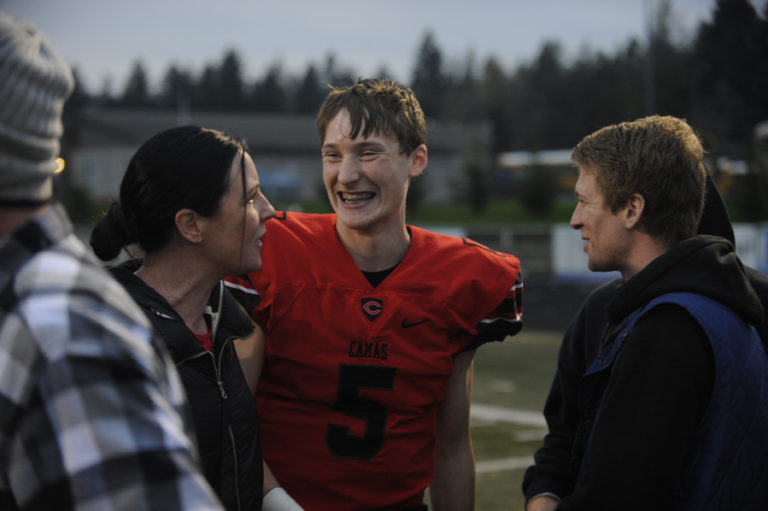 Camas High School senior quarterback Blake Ascuitto celebrates the Papermakers&#039; 41-0 win over Eastmont High Shcool on Nov. 16 win with family and friends.
