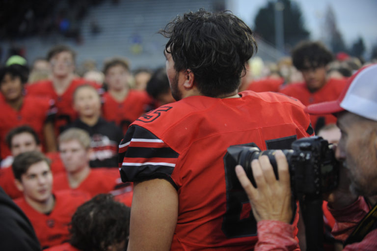 Camas High School senior Tai Tumanuvao pumps up the Papermakers in a postgame celebration ritual at Doc Harris Stadium on Nov. 16.