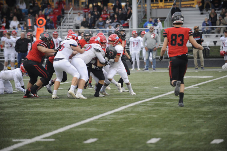 Camas High School junior running back Gabe Guo gets some help from his offensive line as they push together in a pile to pick up an additional 15 yards in the fourth quarter of the Papermakers&#039; Nov. 16 game against Eastmont High School.