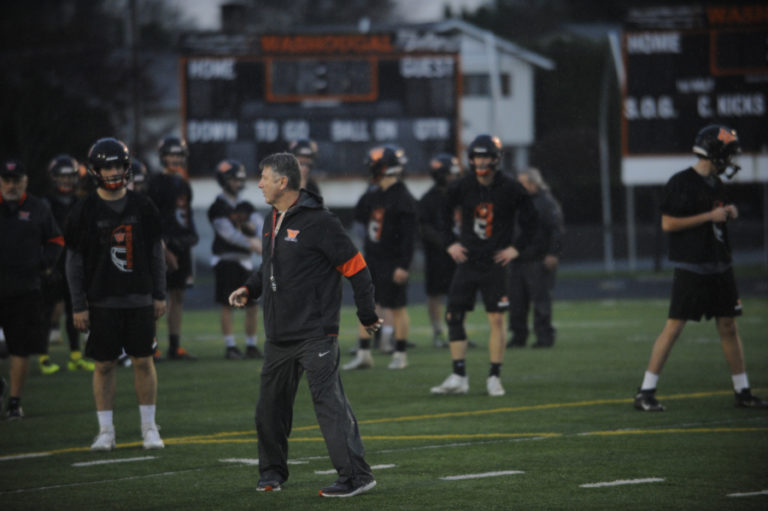 Washougal High School football coach Dave Hajek leads an intense practice session during a driving rainstorm on Nov. 18 in preparation for his team&#039;s 2A state tournament quarterfinal contest against Lynden High School.