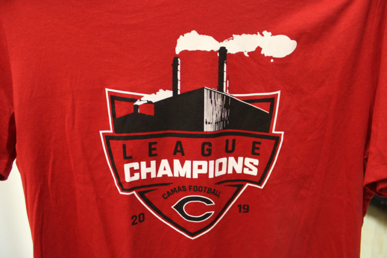 A T-shirt sold at Papermaker Pride features the 2019 Camas High football team&#039;s league championship win -- the team would later go on to win the state 4A football championship -- and an image of the Camas paper mill.