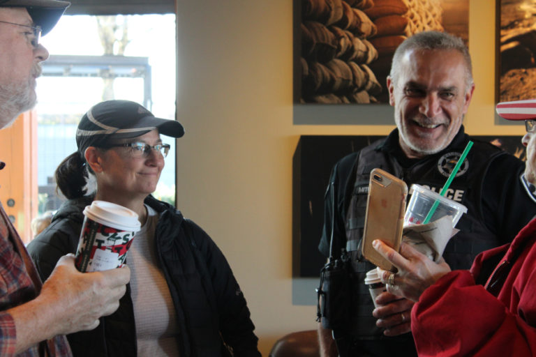 Washougal Police Chief Ron Mitchell (second from right) and Portland Police Commander Wendi Steinbronn (left) talk to community members at a &quot;Coffee with a Cop&quot; event in November 2019.