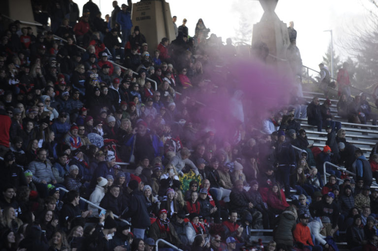 Camas High School students and fans show their colors with red chalk on a near freezing afternoon at McKenzie Stadium on Nov.