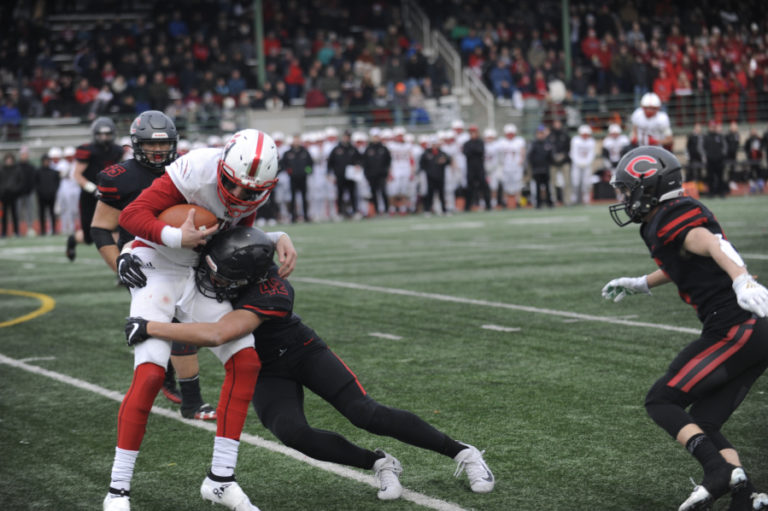 Camas High School sophomore Logan Silva tackles Mount Si High School quarterback Clay Millen on Saturday, Nov. 30, at McKenzie Stadium.