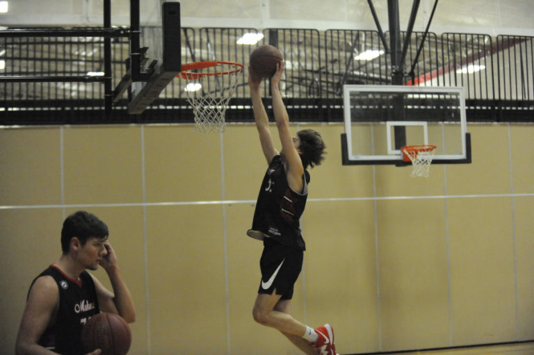 Camas High School junior Blake Bell throws down a dunk during a recent practice session.