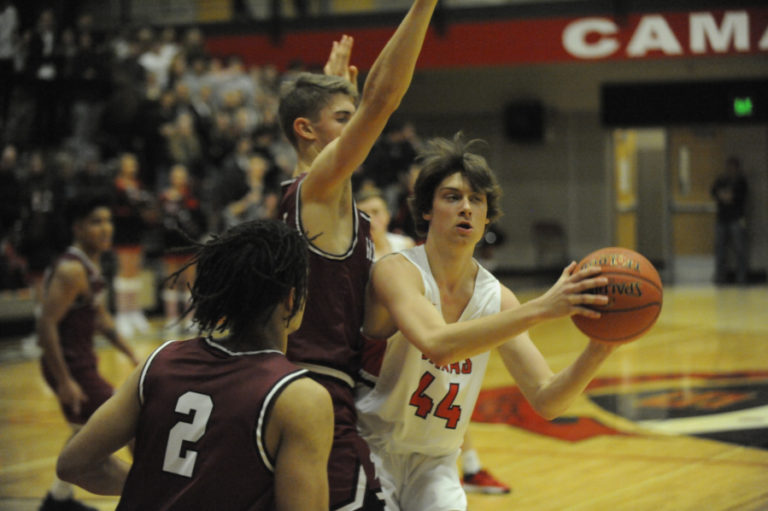 Camas High School junior Blake Bell looks to escape double coverage in the Papermakers&#039; home opener on Dec. 5.
