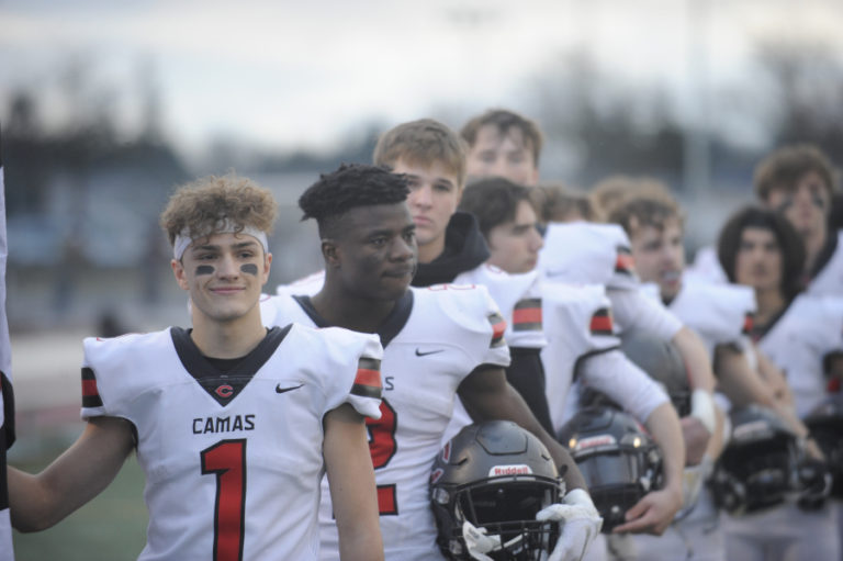 Camas High School&#039;s Robert Edwards, Jacques Badolato-Birdsell and Jake Blair line up with their teammates for the national anthem before the start of the 4A state championship game at Mount Tahoma Stadium on Dec.