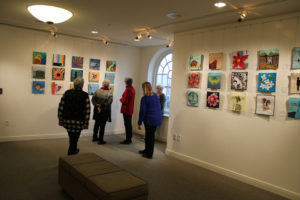 Members of the Vagabonds quilters group examine quilts included in their 