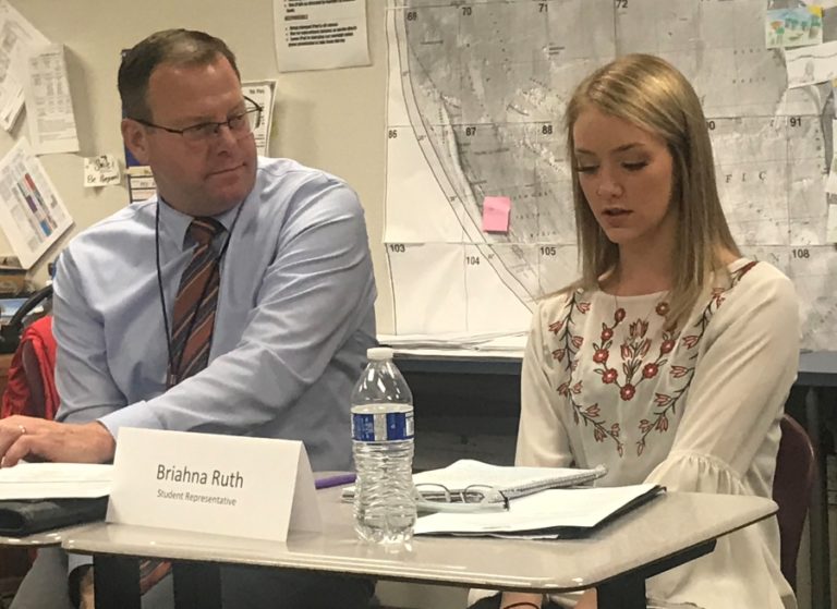 Washougal High School student Briahna Ruth (right) delivers a report to the Washougal School District board of directors during an October meeting at Canyon Creek Middle School.
