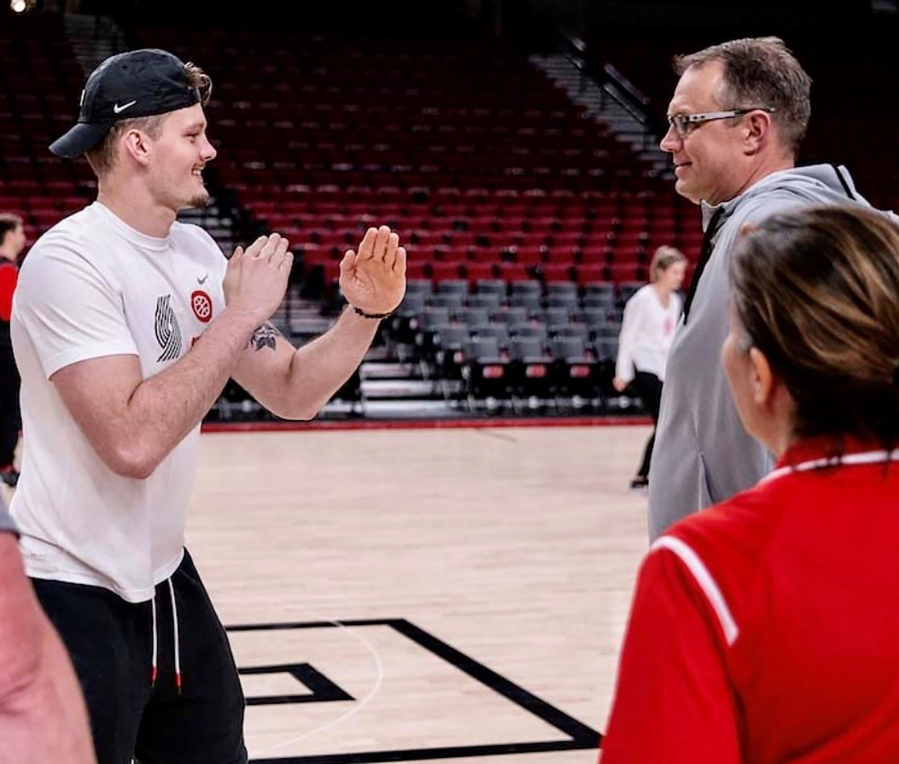 Gause Elementary School physical education specialist Mark Bauer (right) receives instruction during the Trail Blazers PE program, held Dec. 9 at the Moda Center in Portland. (Contributed photo courtesy of Mark Bauer)