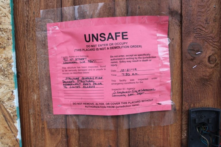 A placard warns of unsafe conditions at a building on Fourth Street in Washougal.