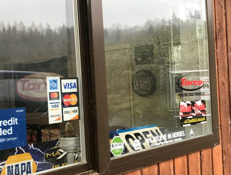 An &#039;open&#039; sign hangs in the window of Mike&#039;s Tire and Auto in Washougal.