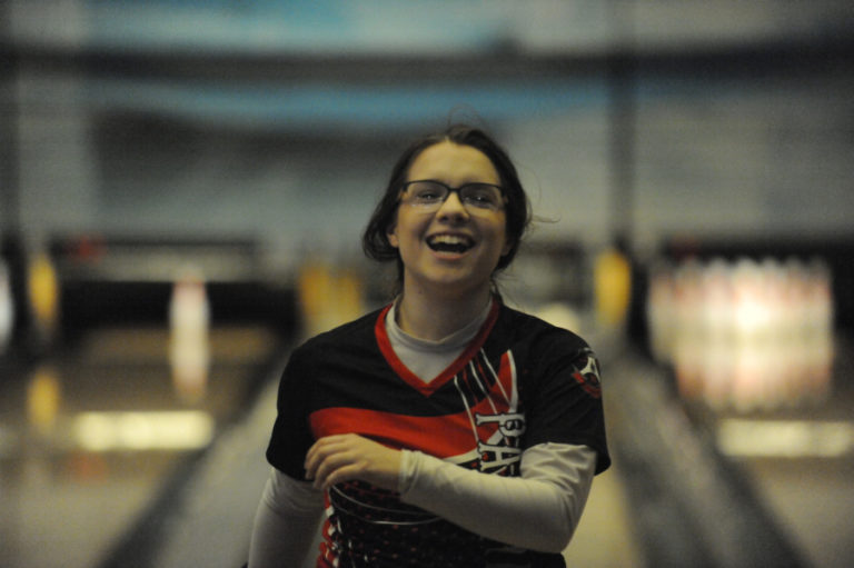 Camas senior Kimmy Boone celebrates after rolling a strike against Union.