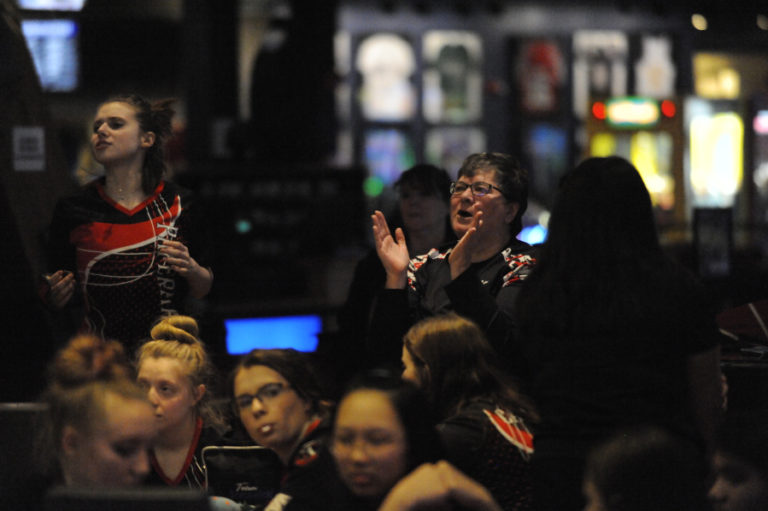 Camas bowling coach Barb Burden (center) claps during a Jan. 15 match in Vancouver.