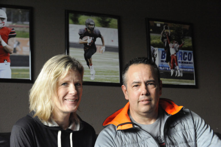 Kris and John Blair show off their television room ,which is filled with pictures of their son Jake, all taken by Kris Cavin.