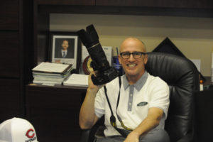Kris Cavin is almost never without his trusty camera, even in his downtown Camas insurance office. (Wayne Havrelly/Post-Record)