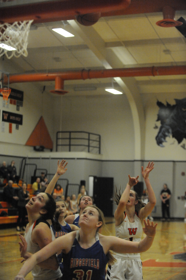 Working hard on the inside, Washougal&#039;s Skylar Bea (left) fights for rebounding position after Jaiden Bea (right) takes a jump shot.