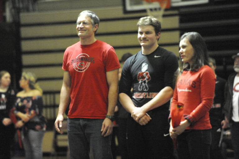 Camas senior Colby Stoller (center) is honored for his contributions to the Camas wrestling program during Senior Night festivities on Jan. 30.