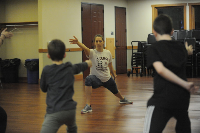 Fencing instructor Julia Tikhanova demonstrates a lunging exercise at the Lacamas Lake Lodge in Camas.