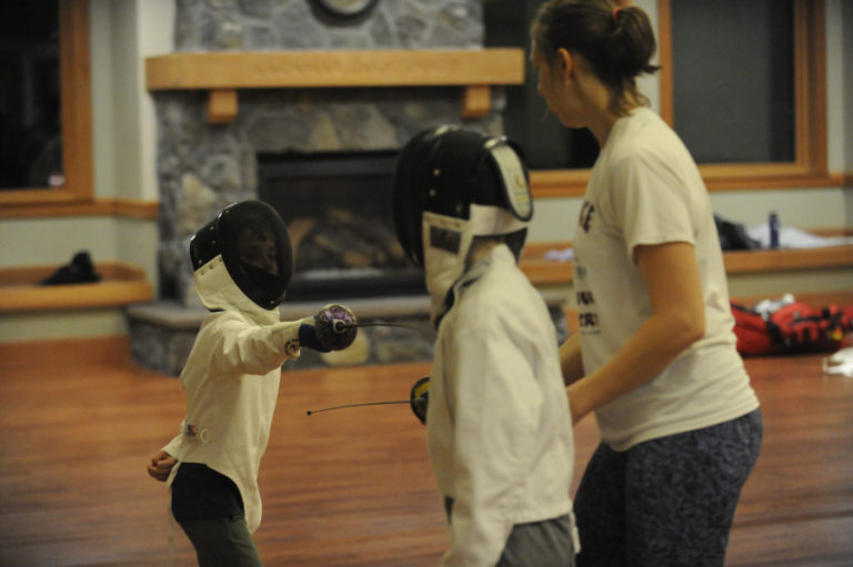 Camas resident Theodore Shreeve, 7, learns fencing technique from former Israeli ntional champion Julia Tikhanova.