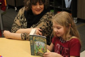 Columbia River Gorge Elementary School principal Tracey MacLachlan (left) reads a book with third-grader Mckinlee Love on Feb. 6.