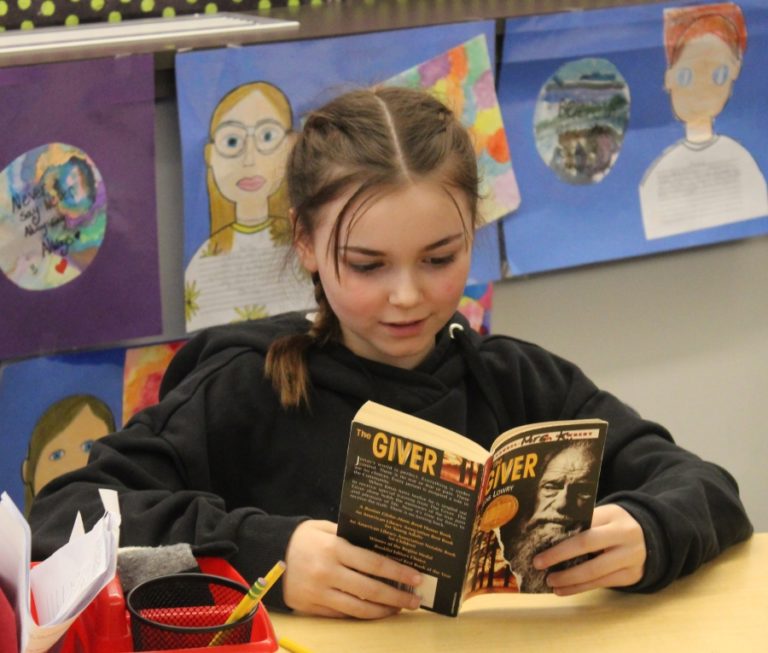 Columbia River Gorge Elementary School student Presley Kosmas reads a book during class on Feb. 6.