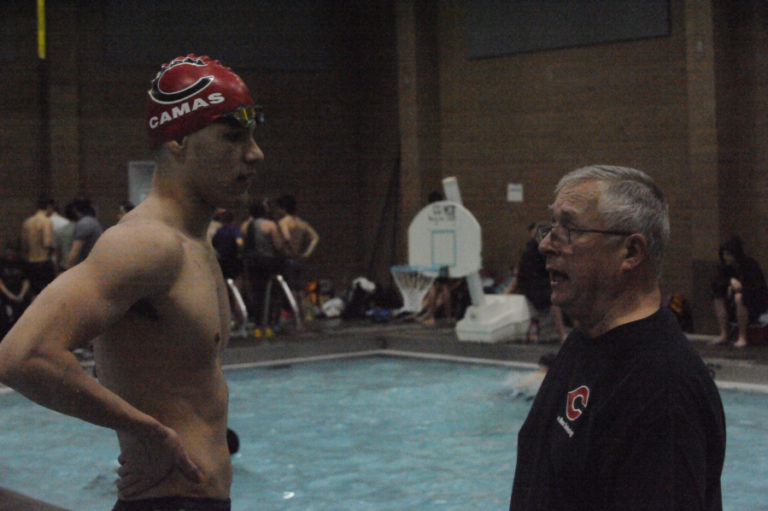 Camas Senior Ben Taylor receives some last-minute advice from coach Mike Bemis at the District 4 championship meet in Kelso on Feb 7.