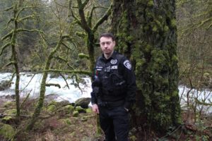 Doug Flanagan/Post-Record 
 Washougal Police Department officer Francis Reagan stands near the the area of the Washougal River where he helped to save a 28-year-old Portland resident who had fallen off her inner tube last May. Reagan was named as the 2019 Officer of the Year by the Washington Council of Police & Sheriffs last week. (Doug Flanagan/Post-Record)