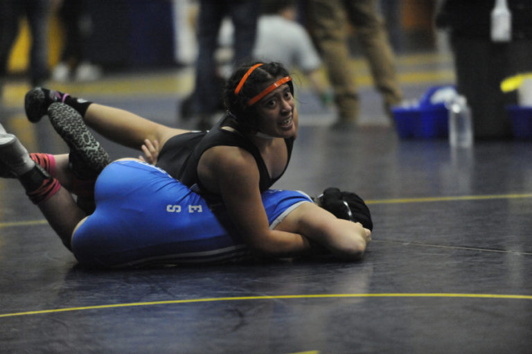 Washougal High School senior Melina Aguilar (top) scraps for positioning in her opening-round match at the Region 3 girls wrestling meet in Kelso, Wash., on Feb. 15. Aguilar qualified for the Mat Classic XXXII, to be held at the Tacoma Dome, Feb. 21-22.