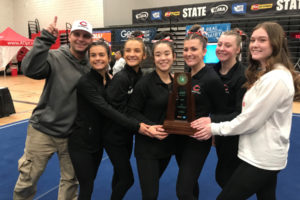 Camas athletic director Rory Oyster (left) celebrates the Camas gymnastics team's 4A state title with seniors (left to right) Annika Affleck, Siena Brophy, Amber Harris, Lizzy Wing, Morgan MacIntyre and Kaitlyn Blair at Sammamish High School on Feb. 22. (Contributed photo courtesy of Carol Willson)