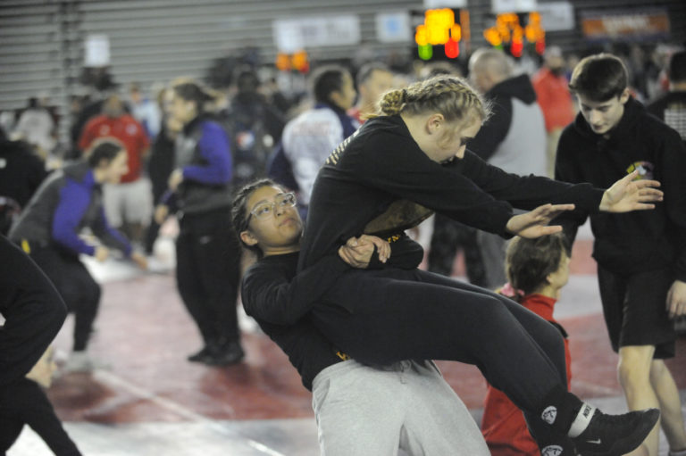 Washougal&#039;s Melina Aguilar (left) and Ashley Garrison (right) warm up prior to the first round of Mat Classic XXXII at the Tacoma Dome on Feb. 21.