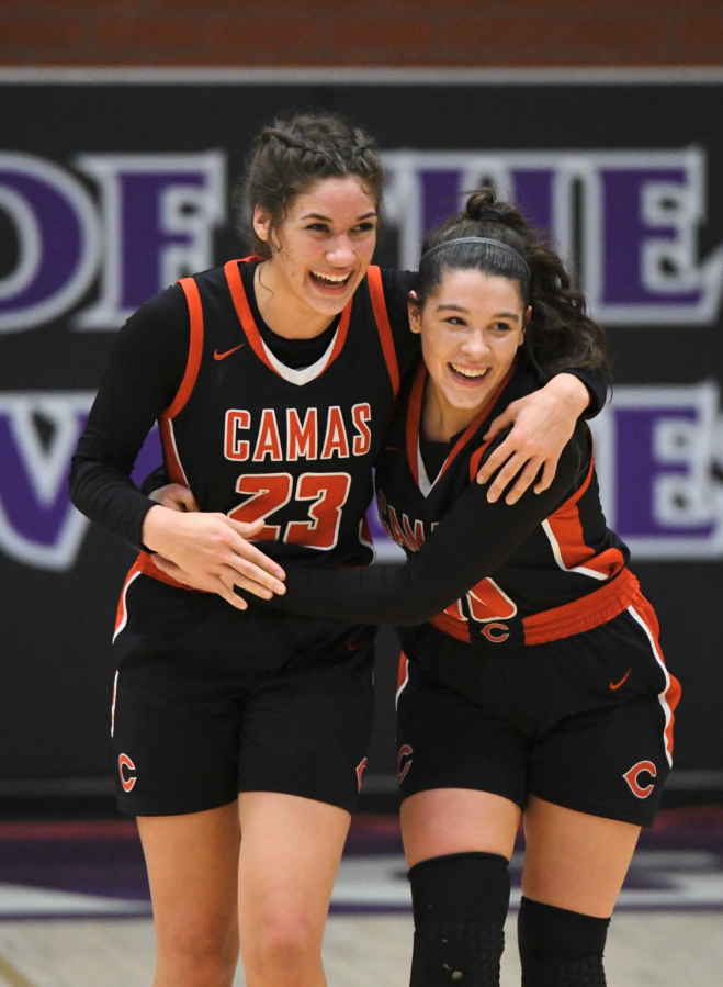 Camas basketball players Jalena Carlisle and Katelynn Forner celebrate after beating the Papermakers beat Skyview on Feb. 18 to secure a berth to the 4A state regional round.