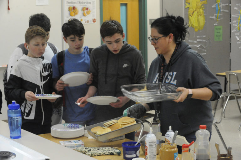 Canyon Creek Middle School eighth-grade students are served pancakes as part of the school&#039;s 100 Percent Day event, held March 6.