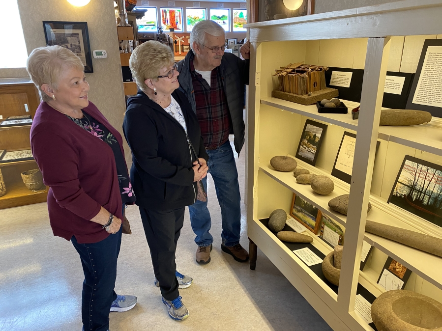 Karen Meisner (left), Nita Brigham (center) and Larry Lund explore Two Rivers Heritage Museum on Thursday, March 5.