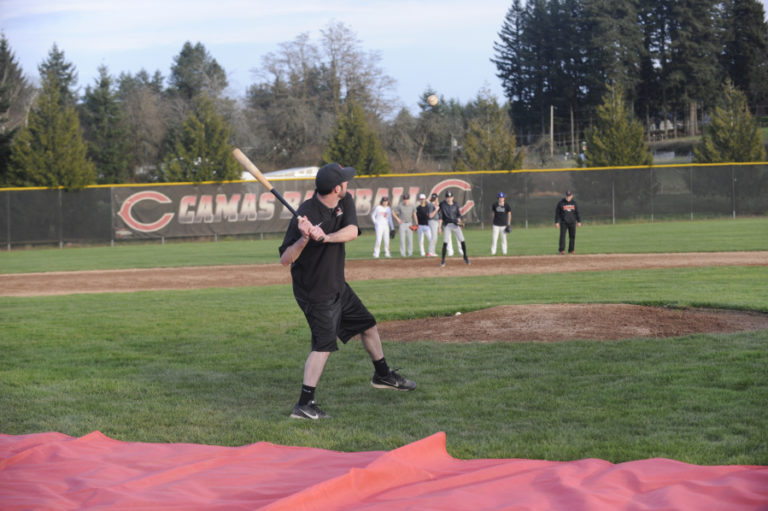 Camas baseball coach Stephen Short hits balls during a drill at a recent practice session.