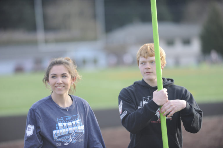 Washougal High junior Katie Stevens and senior Scott Lees focus on their coach during a recent practice session at Fishback Stadium in Washougal.