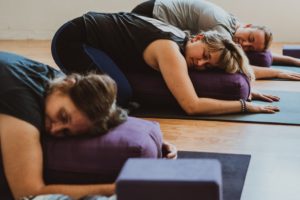 (Contributed photo by Aleya Burg courtesy of Body Bliss) Body Bliss yoga studio owner Jacquie Michelle (center) practices in her downtown Camas yoga studio. The studio, along with other Washington state gyms and recreation facilities, has closed due to the COVID-19 pandemic, but plans to livestream classes for members and the community. 