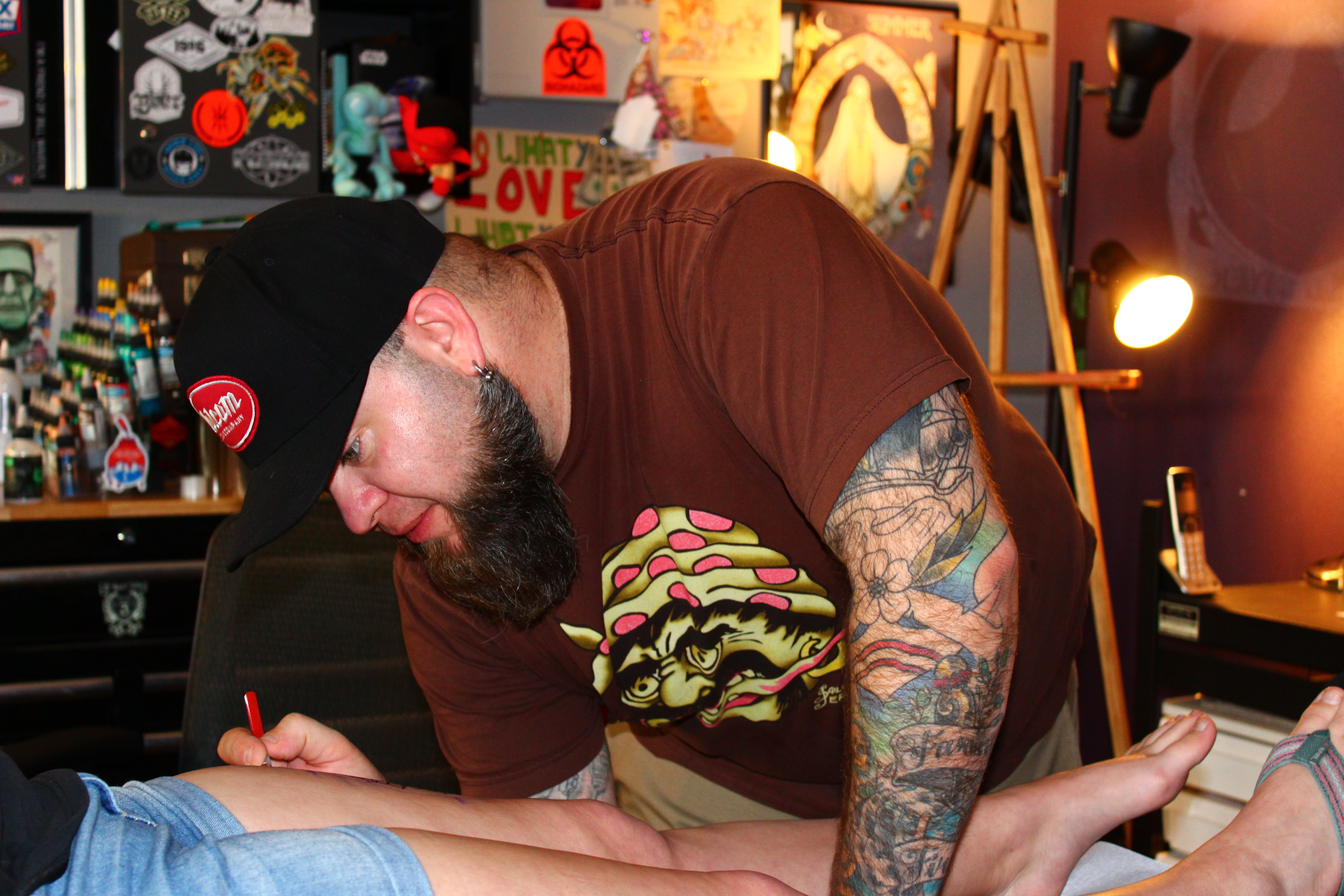  (Post-Record file photo) Ryan Boomhower, owner of 3rd Heart Tattoo in downtown Washougal, prepares his client, Tiffany Renteria, of Vancouver, for her new tattoo, in April 2018.